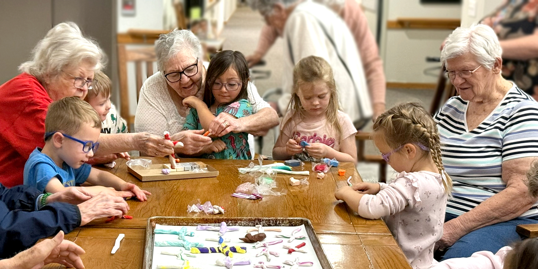 Residents and Acorns & Oaks preschool students making prayer crosses.